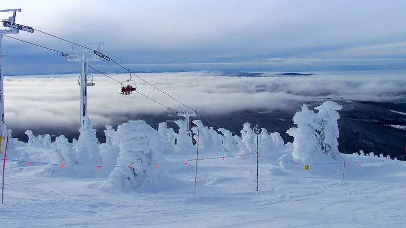 Snow ghosts and a chairlift above a sea of cloud at Big White